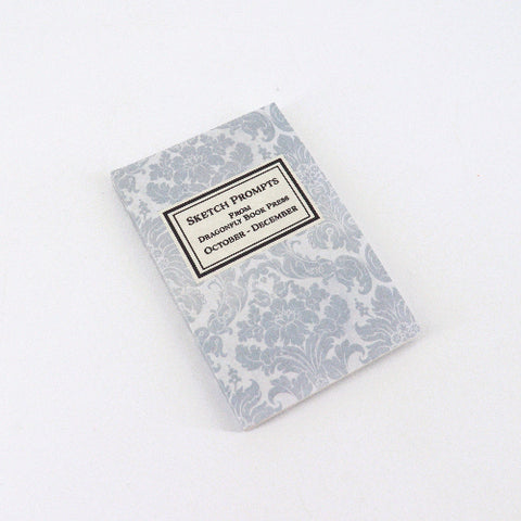 Notebook with decorative cover and text on a white background