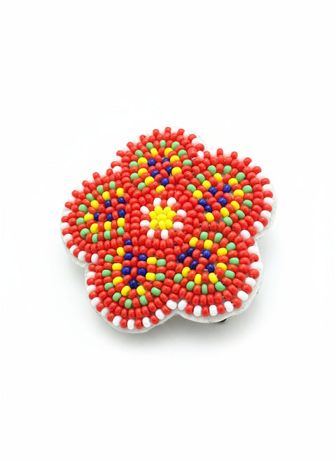 Colorful bead coaster on a brown textured surface