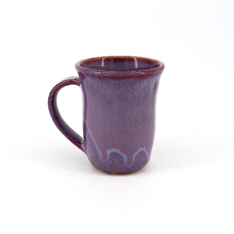 Handmade purple pottery mug by Shirley Randall, featuring a smooth ceramic finish and a rounded handle.